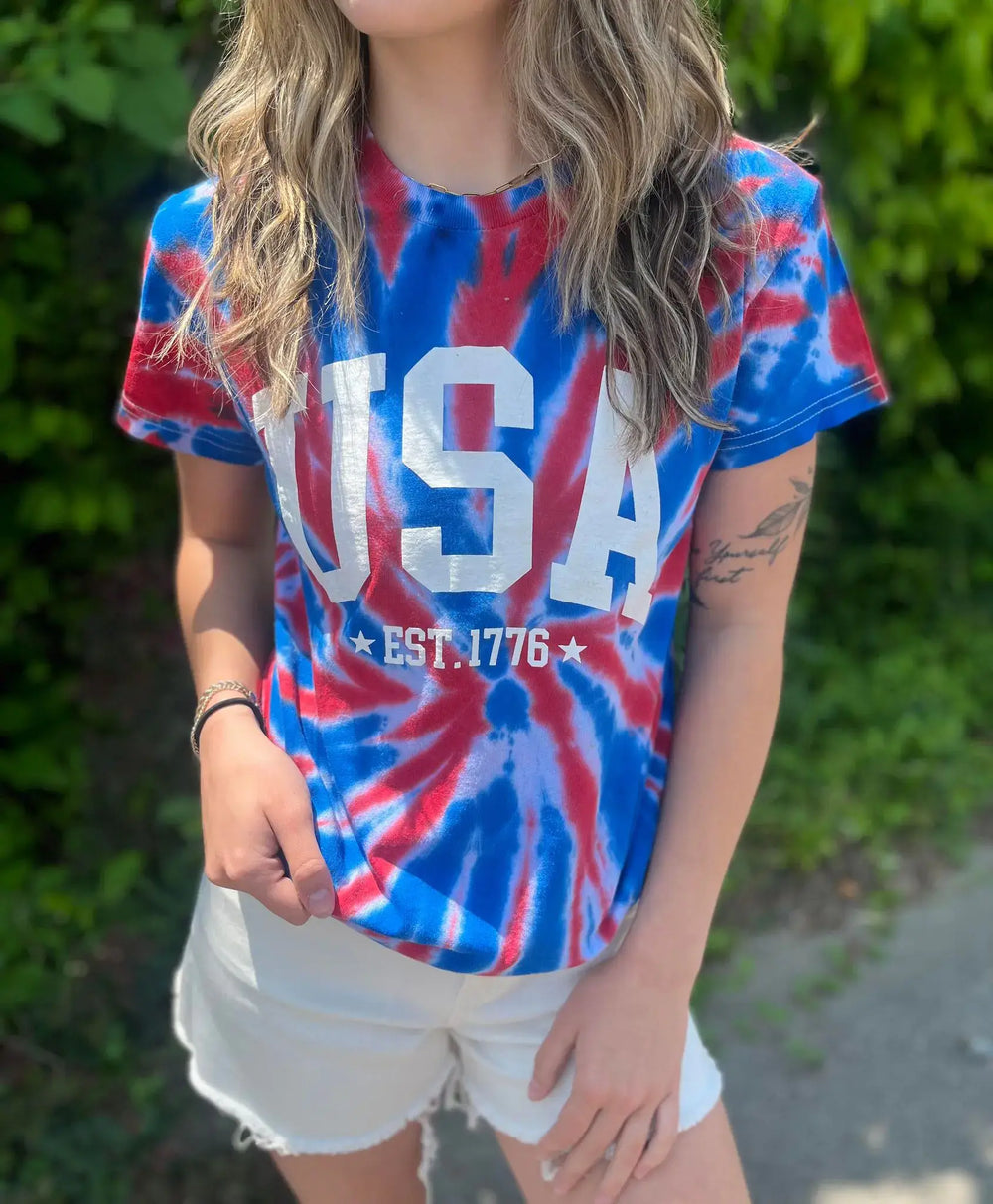 Tie Dye USA Tee Okay, we really did something with this one! Rock the Fourth Of July cookout (or anywhere else really) in this stunning tie dye tee! Model is wearing a size Small, her true size. $35.0 to $35.0