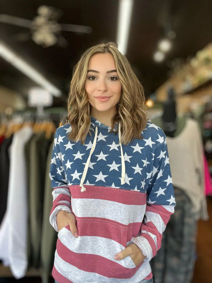 American Flag Hoodie This hoodie is perfect for the whole family! Super soft with pockets, completely wrapped in the American Flag! Perfect year round! Model is wearing size Small, her true size. $55.0 to $55.0